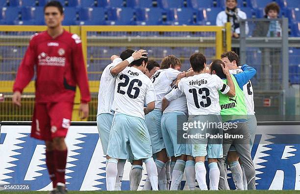 Sergio Floccari with Stefan Radu , Sebastiano Siviglia and players of SS Lazio celebrate the second goal as player of Livorno shows his dejection...