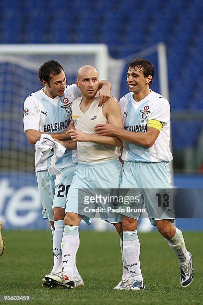 Tommaso Rocchi of Lazio is congratulated by Sebastiano Siviglia and Stefan Radu of SS after scoring the third goal during the Serie A match between...