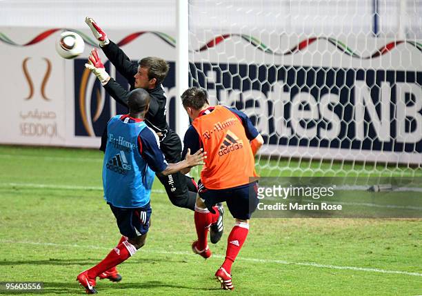 Goalkeeper Michael Rensing of Bayern Muenchen saves the ball during the FC Bayern Muenchen training session at the Al Nasr training ground on January...