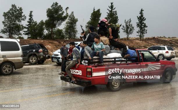 Children ride in the back of a pickup truck with Turkey-backed fighters as they drive in Abu al-Zandin checkpoint near al-Bab in northern Syria on...