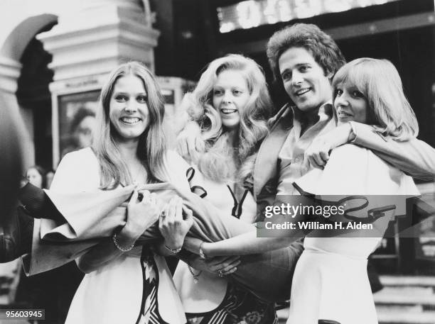 Irish singer and songwriter Gilbert O'Sullivan poses outside the London Palladium with Vonni Barnes, Veronica France and Denny Fone, who are starring...