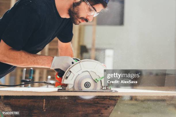 Man Using Saw 7,022 Man Using Circular Saw Stock Photos, High-Res Pictures, and ...