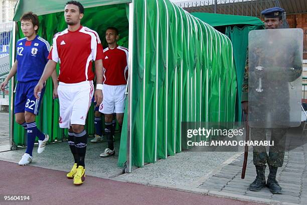 Yemeni riot policeman stands guard as Japanese and Yemeni players arrive at the stadium in Sanaa before the start of their Asian Cup 2011 qualifying...