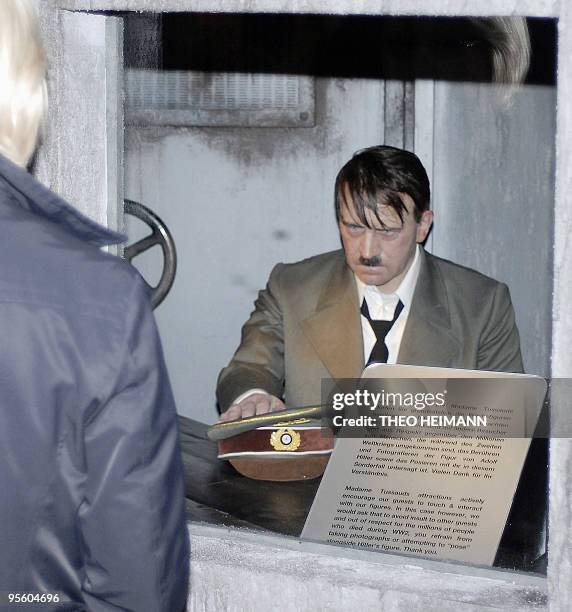 Visitor takes a look at the waxwork statue of Adolf Hitler at Madame Tussauds waxworks museum in Berlin on September 13, 2008 as it returend to the...