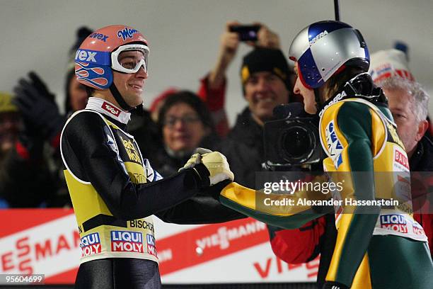 Andreas Kofler of Austria celebrates with his team mate Gregor Schlierenzauer after final round for the FIS Ski Jumping World Cup event of the 58th...