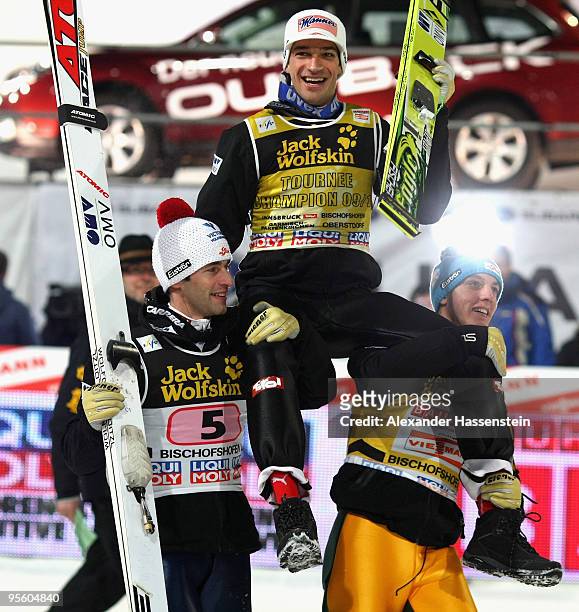Andreas Kofler of Austria celebrates winning the 58th Four Hills ski jumping tournament with his team mates Wolfgang Loitzl and Gregor Schlierenzauer...