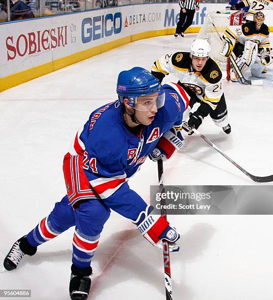 Ryan Callahan of the New York Rangers skates under pressure by Andrew Ference of the Boston Bruins on January 4, 2010 at Madison Square Garden in New...