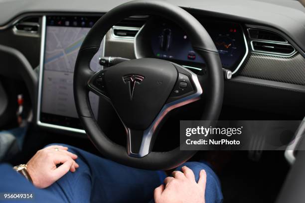 Dan Kiely, CEO &amp; Co Founder of Voxpro, takes his hands off the wheel of his Tesla Model S P100D at a launch event for the MobilityX self-driving...