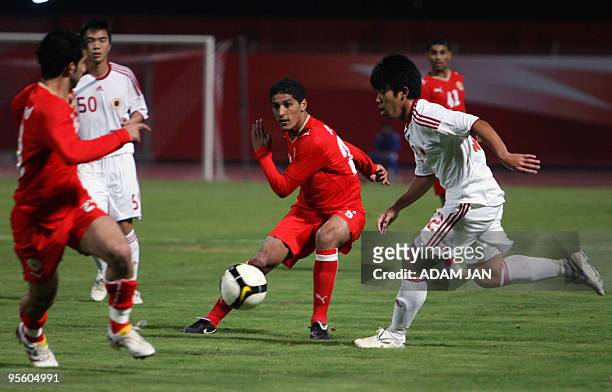 Hong Kong's Tse Tak Him competes with unidentified Bahraini players during their Asian Cup Group A qualifier in Manama on January 6, 2010. Ismail...