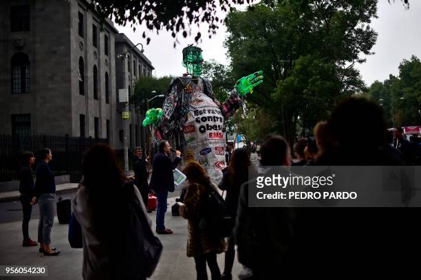 Activists move a dummy made of recycled materials depicting Frankentein's monster during a protest against the public policy on obesity in Mexico...
