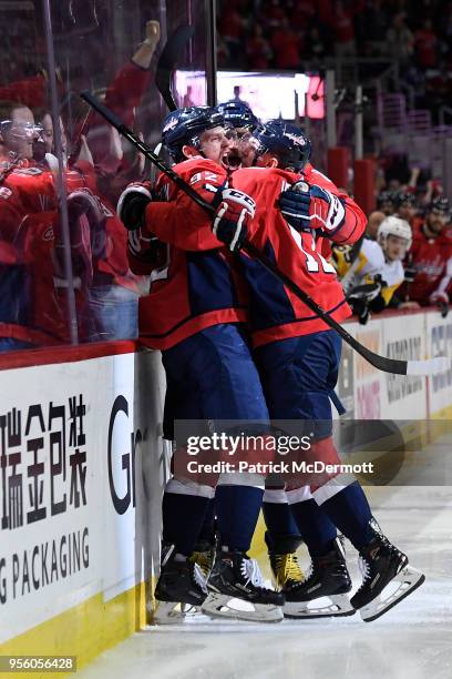 Evgeny Kuznetsov of the Washington Capitals celebrates with his teammates after scoring a third period goal against the Pittsburgh Penguins in Game...