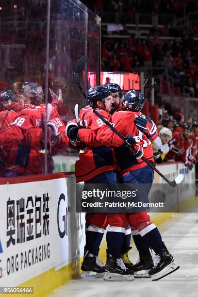 Evgeny Kuznetsov of the Washington Capitals celebrates with his teammates after scoring a third period goal against the Pittsburgh Penguins in Game...