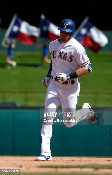 Ryan Rua of the Texas Rangers rounds the bases after hitting a solo home run against the Boston Red Sox during the seventh inning at Globe Life Park...