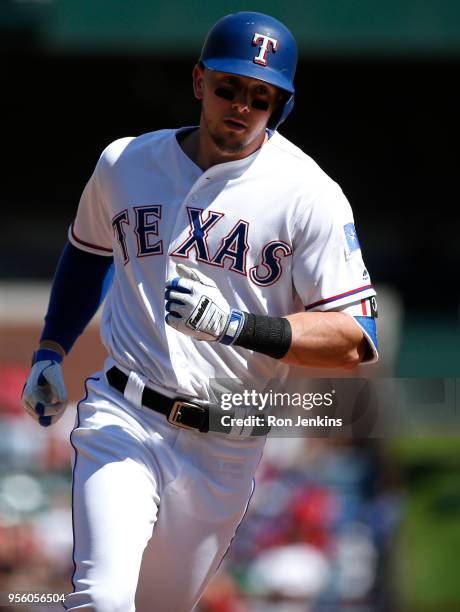 Ryan Rua of the Texas Rangers rounds the bases after hitting a solo home run against the Boston Red Sox during the seventh inning at Globe Life Park...