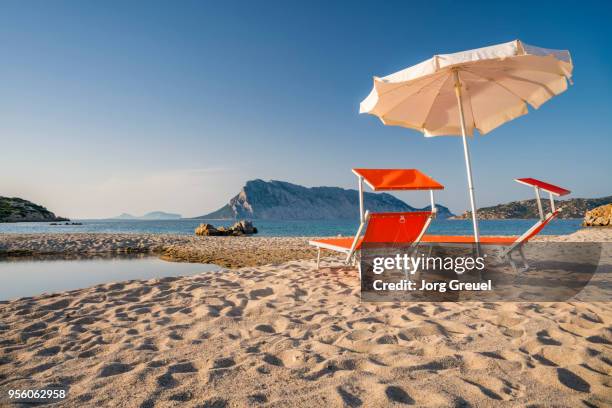 deck chairs on beach - olbia stock pictures, royalty-free photos & images