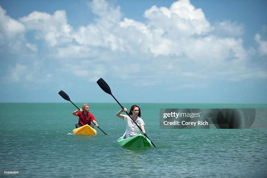 A man and woman kayak in Florida.