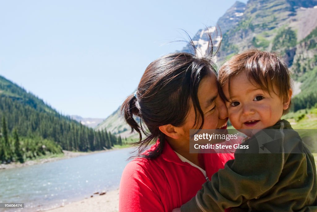 A mother and her child at Crater Lake in the Maroon Bells in Snowmass Wilderness on a multi-day back