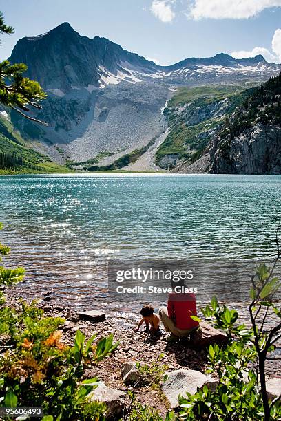 a mother and her 14 month old son play on the shore of snowmass lake (10,980ft) on august 10, 2009 i - maroon bells summer stock pictures, royalty-free photos & images