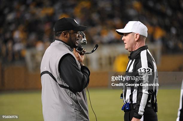 Head coach Mike Tomlin of the Pittsburgh Steelers talks with referee John Parry during a game against the Green Bay Packers at Heinz Field on...