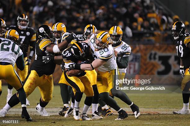 Linebacker A.J. Hawk of the Green Bay Packers tackles running back Willie Parker of the Pittsburgh Steelers at Heinz Field on December 20, 2009 in...