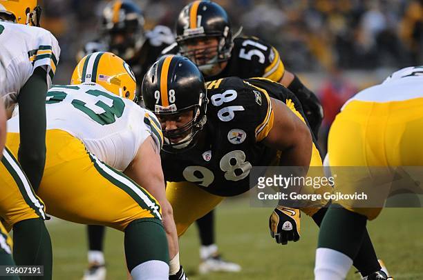 Defensive lineman Casey Hampton of the Pittsburgh Steelers looks across the line of scrimmage at center Scott Wells of the Green Bay Packers during a...