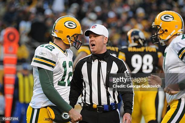 National Football League referee John Parry talks to quarterback Aaron Rodgers of the Green Bay Packers during a game against the Pittsburgh Steelers...
