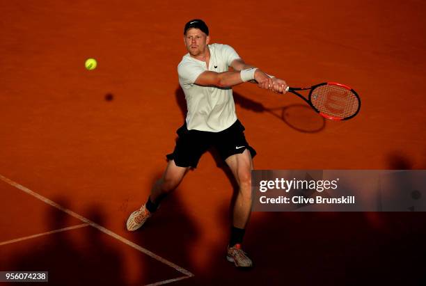 Kyle Edmund of Great Britain plays a backhand in his match against Daniil Medvedev of Russia during day four of the Mutua Madrid Open tennis...