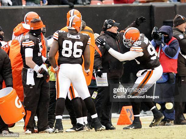 Head coach Eric Mangini of the Cleveland Browns receives a congratulatory hug from linebacker David Bowens as the final seconds tick away during a...