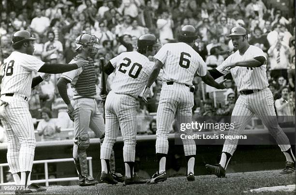 Chris Chambliss of the New York Yankees is congratulated by teammates Bucky Dent, Roy White and Carlos May after hitting a three-run home run during...