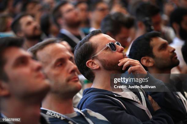 Attendees look on as Google CEO Sundar Pichai delivers the keynote address at the Google I/O 2018 Conference at Shoreline Amphitheater on May 8, 2018...