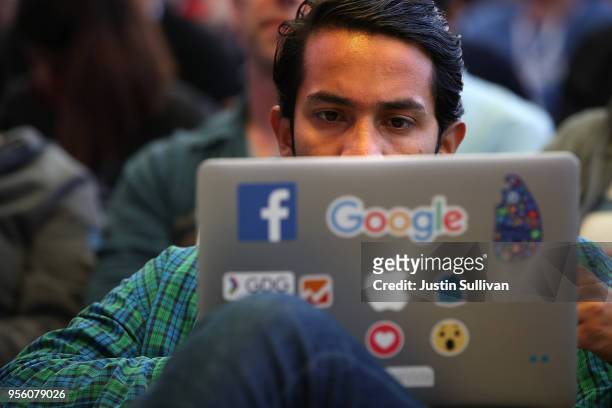 An attendee works on a laptop before the start of the Google I/O 2018 Conference at Shoreline Amphitheater on May 8, 2018 in Mountain View,...
