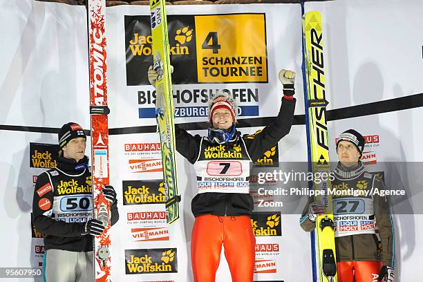 Thomas Morgenstern of Austria takes 1st place, ) Janne Ahonen of Finland takes 2nd place, Simon Ammann of Switzerland takes 3rd place pose during for...