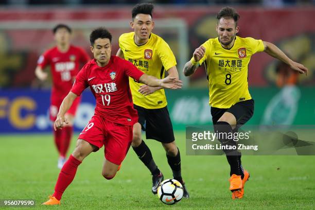 Wang Xiaolong of Tianjin Quanjian competes the ball with Nemanja Gudelj of Guangzhou Evergrande during the AFC Champions League Round of 16 first leg...