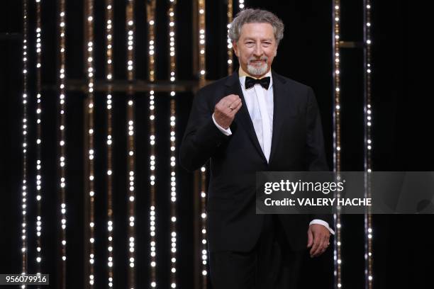 French director and member of the Feature Film Jury Robert Guediguian gestures as he arrives on stage on May 8, 2018 for the opening ceremony of the...