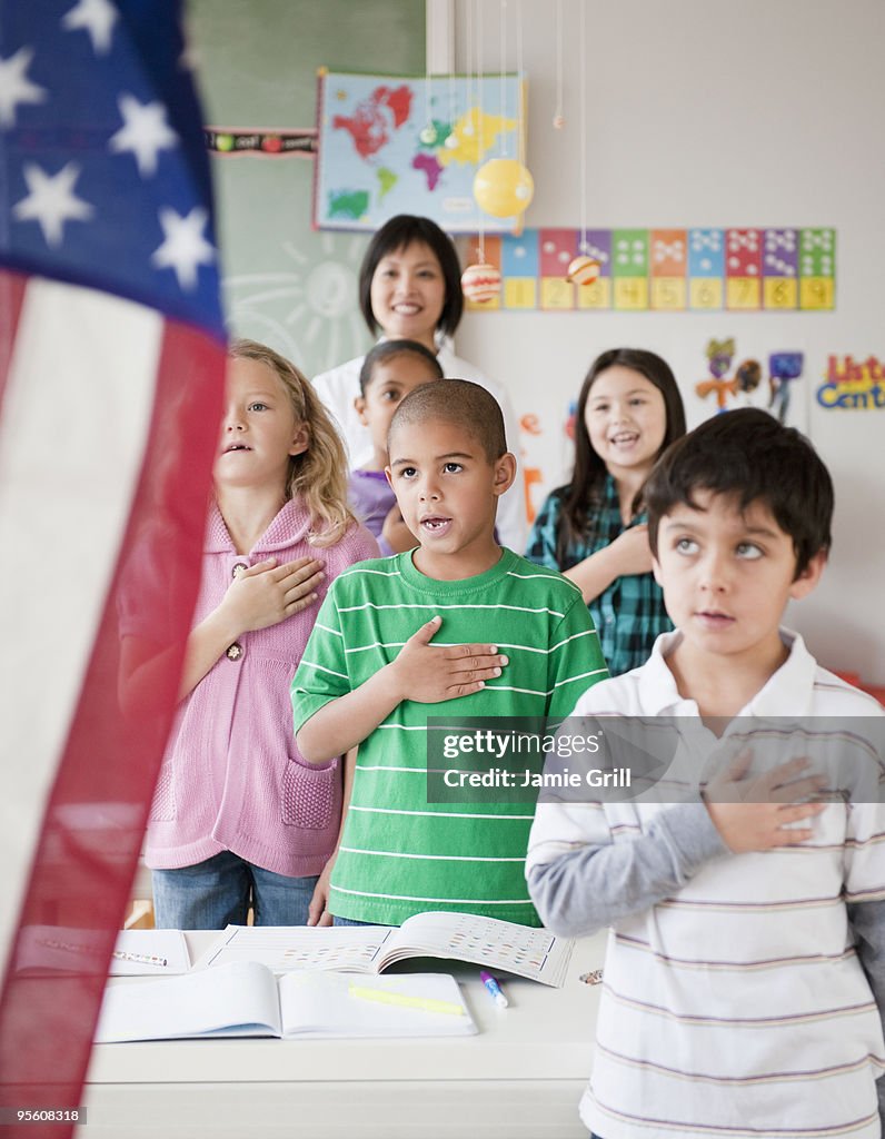 Teacher and students reciting pledge of allegiance