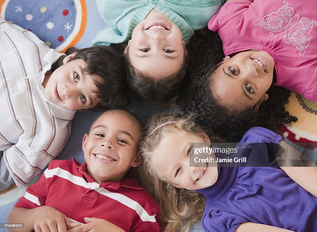 High angle view of children lying on floor