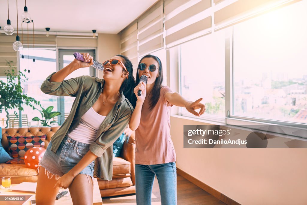 Two friends having fun singing together