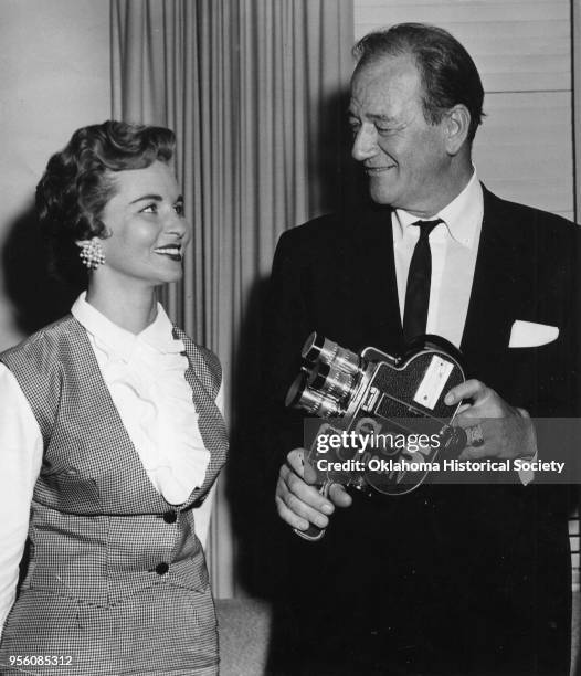 Photograph of Ida Blackburn and John Wayne holding a KOCO-TV Channel 5 Camera, Oklahoma, 1960.