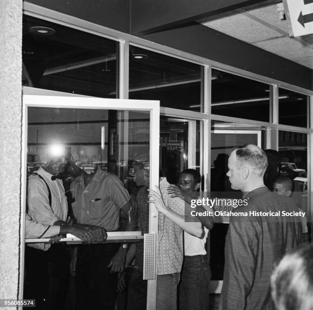 Photograph of an African American Civil Rights segregation protest led by Clara Luper at Bishop's Restaurant at 113 North Broadway, Oklahoma City,...