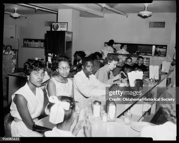 Photograph of Carolyn House, Brenda Officer, Paul Anderson, and other people at an African American Civil Rights sit-in segregation protest at John A...