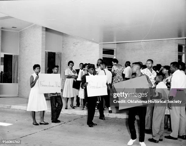 Photograph of A Willie James, Billye Reid and others holding signs reading 'Freedom Now' during a sit-in at Capitol Hill, Oklahoma City, Oklahoma,...