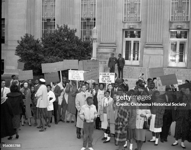 Photograph of Church Leaders and a crowd of Civil Rights activists, mostly young adults, holding signs, gathered in front of the Municipal Building,...