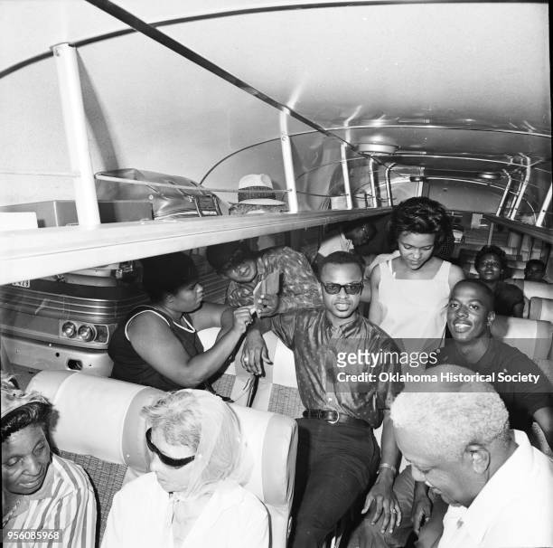 Photograph of people aboard a bus at Douglass High School who are preparing to leave for the National NAACP convention , Oklahoma City, Oklahoma,...