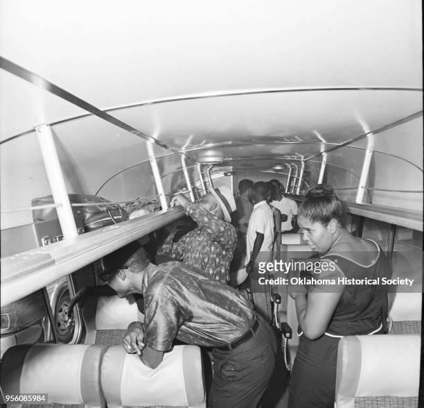 Photograph of people on board a charter bus at Douglass High School, Oklahoma City, Oklahoma, August 26, 1963. They are on their way to participate...