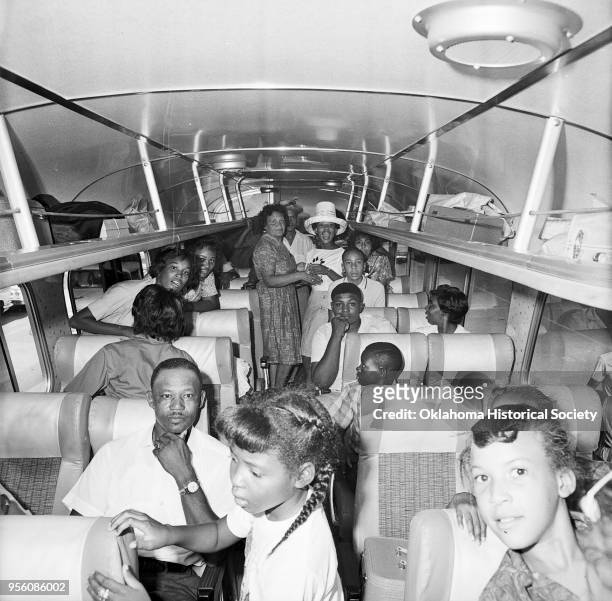 Photograph of Nancy Lynn Davis, Robert Dowell, and others on a chartered bus at Douglass High School, Oklahoma City, Oklahoma, August 26, 1963. They...