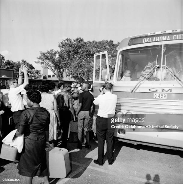 Photograph of Ronald Benefee, Dwayne Crosby, and others on a chartered bus at Douglass High School, Oklahoma City, Oklahoma, August 26, 1963. They...