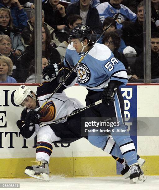 Kris Letang of the Pittsburgh Penguins checks Vyacheslav Kozlov of the Atlanta Thrashers in the first period at Mellon Arena on January 5, 2010 in...