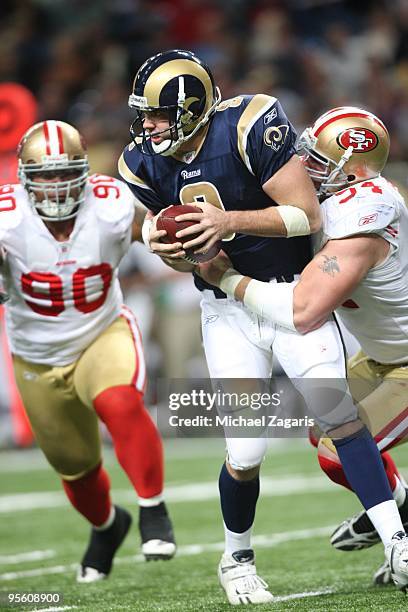 Keith Null of the St. Louis Rams is sacked by Justin Smith of the San Francisco 49ers during the NFL game at Edward Jones Dome on January 3, 2010 in...