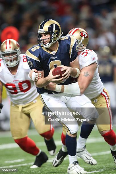 Keith Null of the St. Louis Rams is sacked by Justin Smith of the San Francisco 49ers during the NFL game at Edward Jones Dome on January 3, 2010 in...