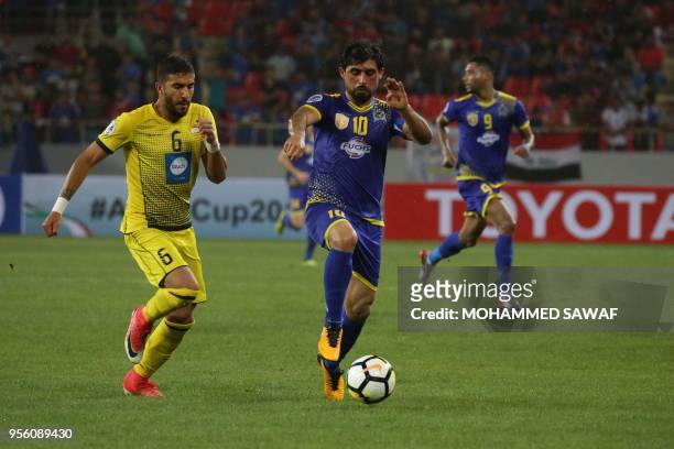 Al-Quwa al-Jawiya's Iraqi striker Hammadi Ahmad vies for the ball against Al-Ahed SC's Lebanese defender Hussein Al Zain during their AFC Cup...